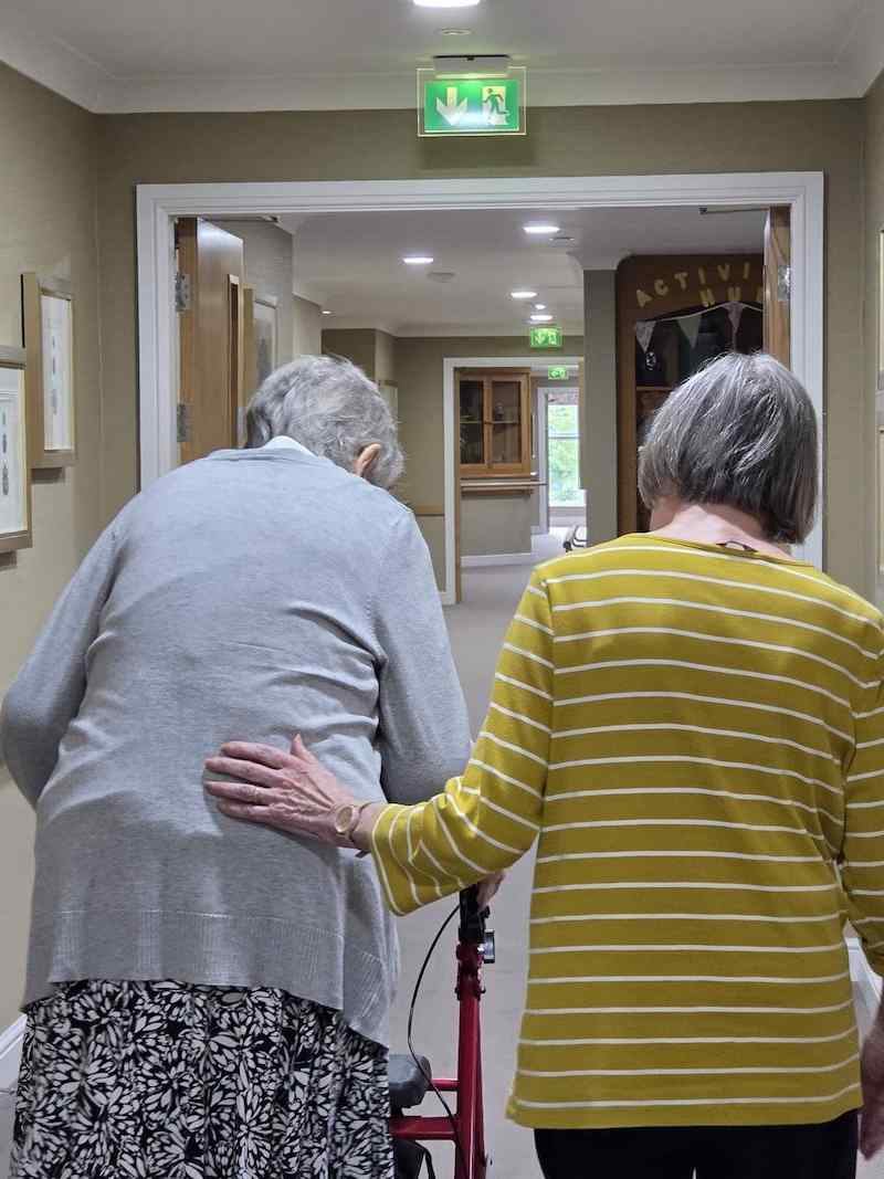 2 of our residents walking together down the corridor
