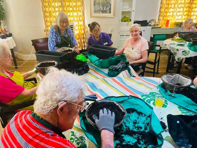 a group of our residents doing gardening at the table