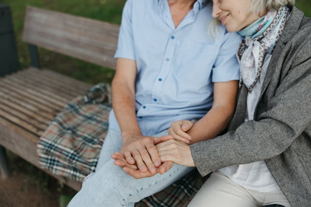 A resident and carer sat on a bench