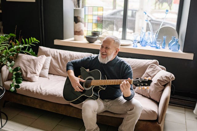 An older man playing guitar