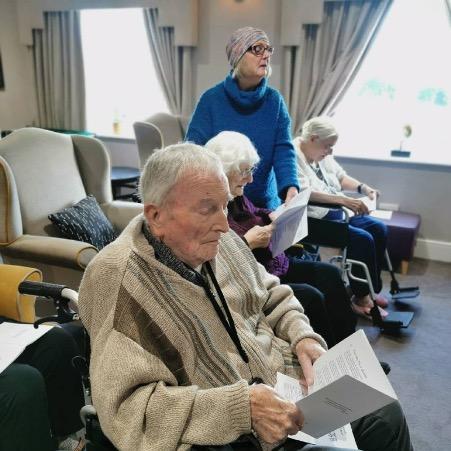 residents reading hymn books