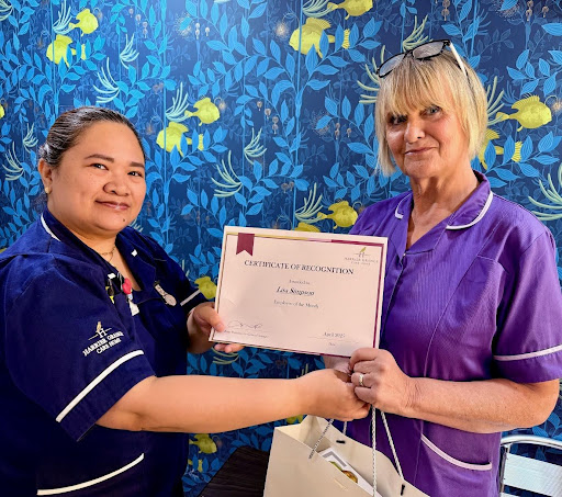 our employees of the month stood together holding certificate