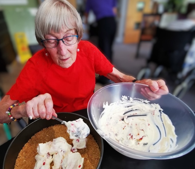 resident making cheesecake in baking club