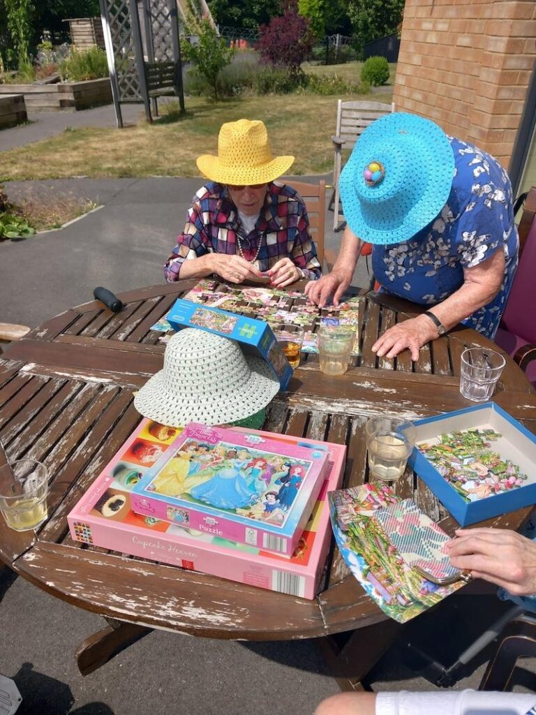 group of residents sat together doing a puzzle