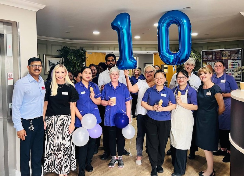 our team with balloons smiling