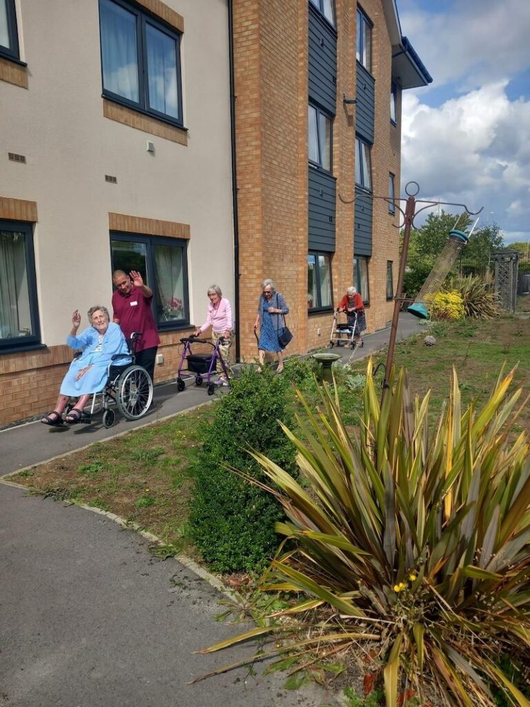 a group of our residents on a walk with carers