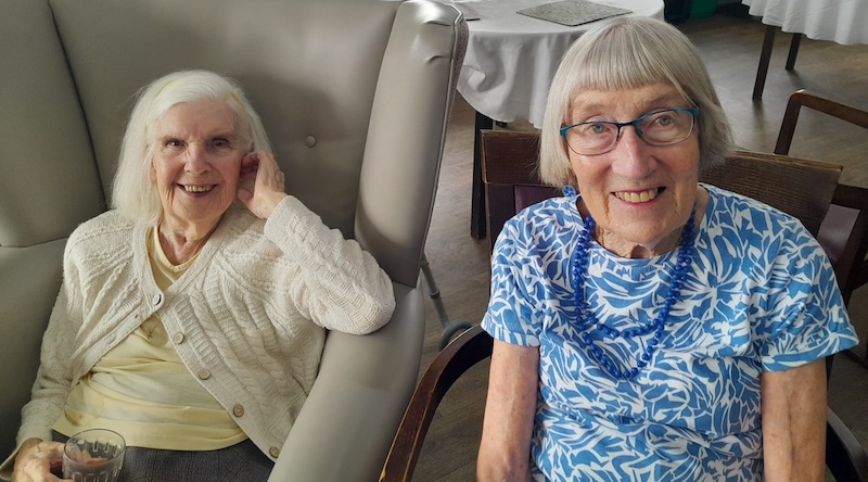 residents sat down together smiling