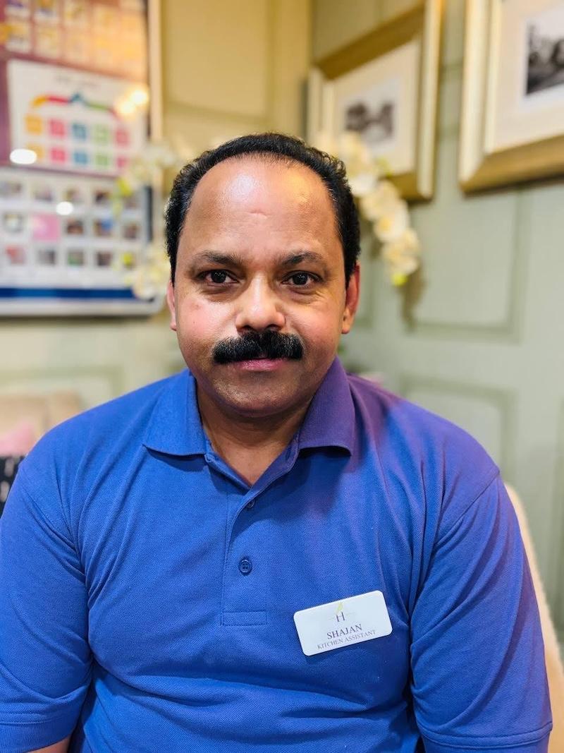 Shajan our kitchen assistant having his headshot taken for the team page