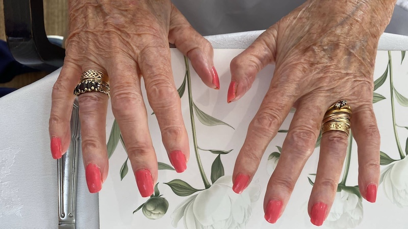 older womans hands after having her nails painted