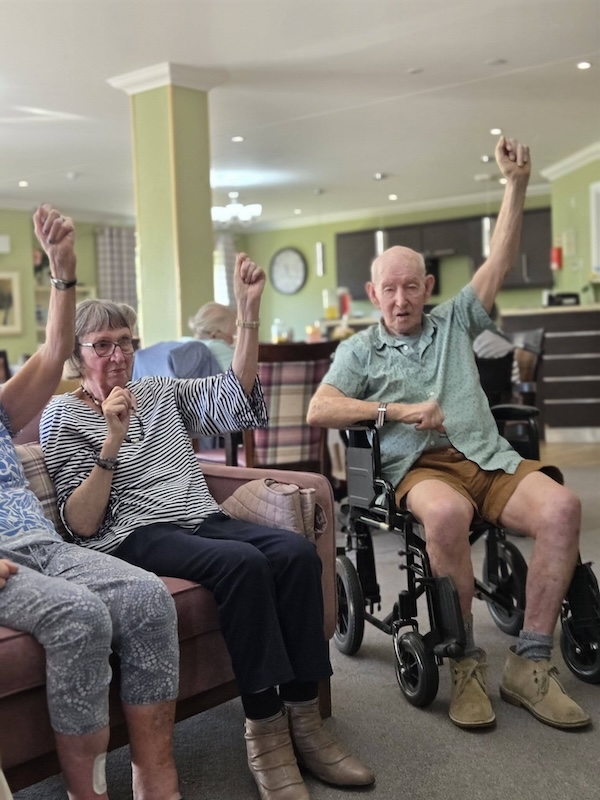 residents raising their arms exercising